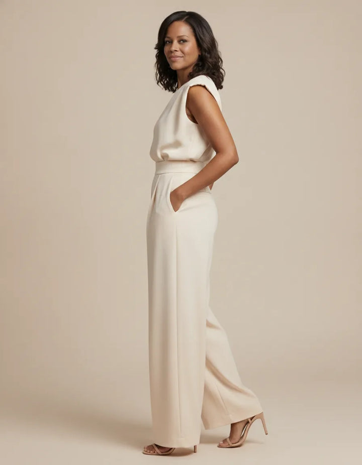 Effortless elegance and a flattering silhouette define the beautiful Clara Jumpsuit. — Beige