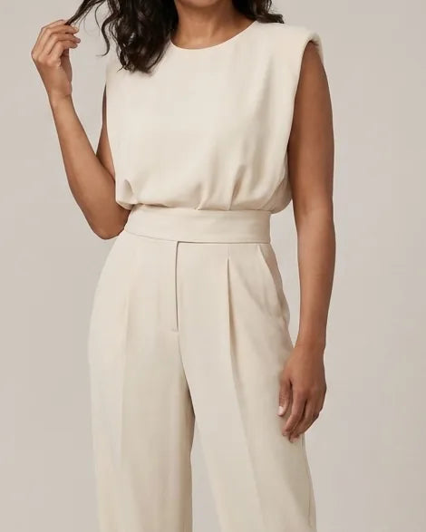 Effortless elegance and a flattering silhouette define the beautiful Clara Jumpsuit. — Beige